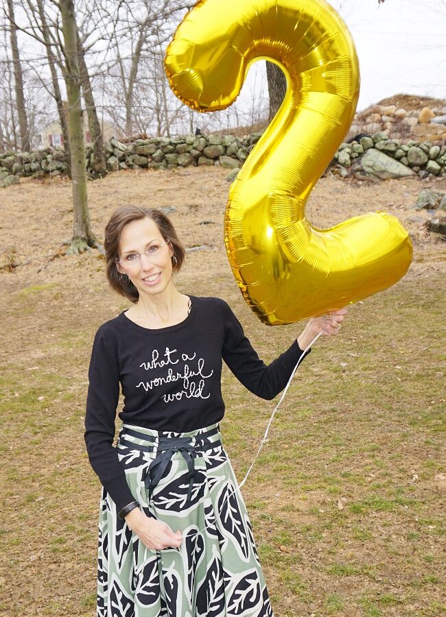 Jennifer Leal holding a large gold number two balloon to celebrate her 2-year post stem cell anniversary